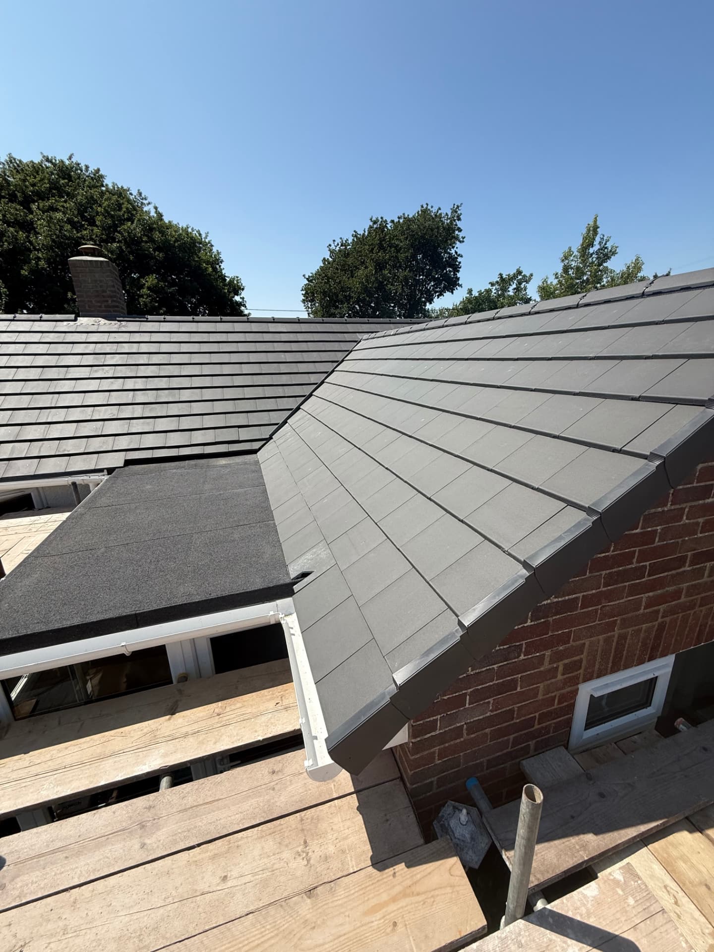 Hipped roof re-covered in artificial slate with new ridge and trims