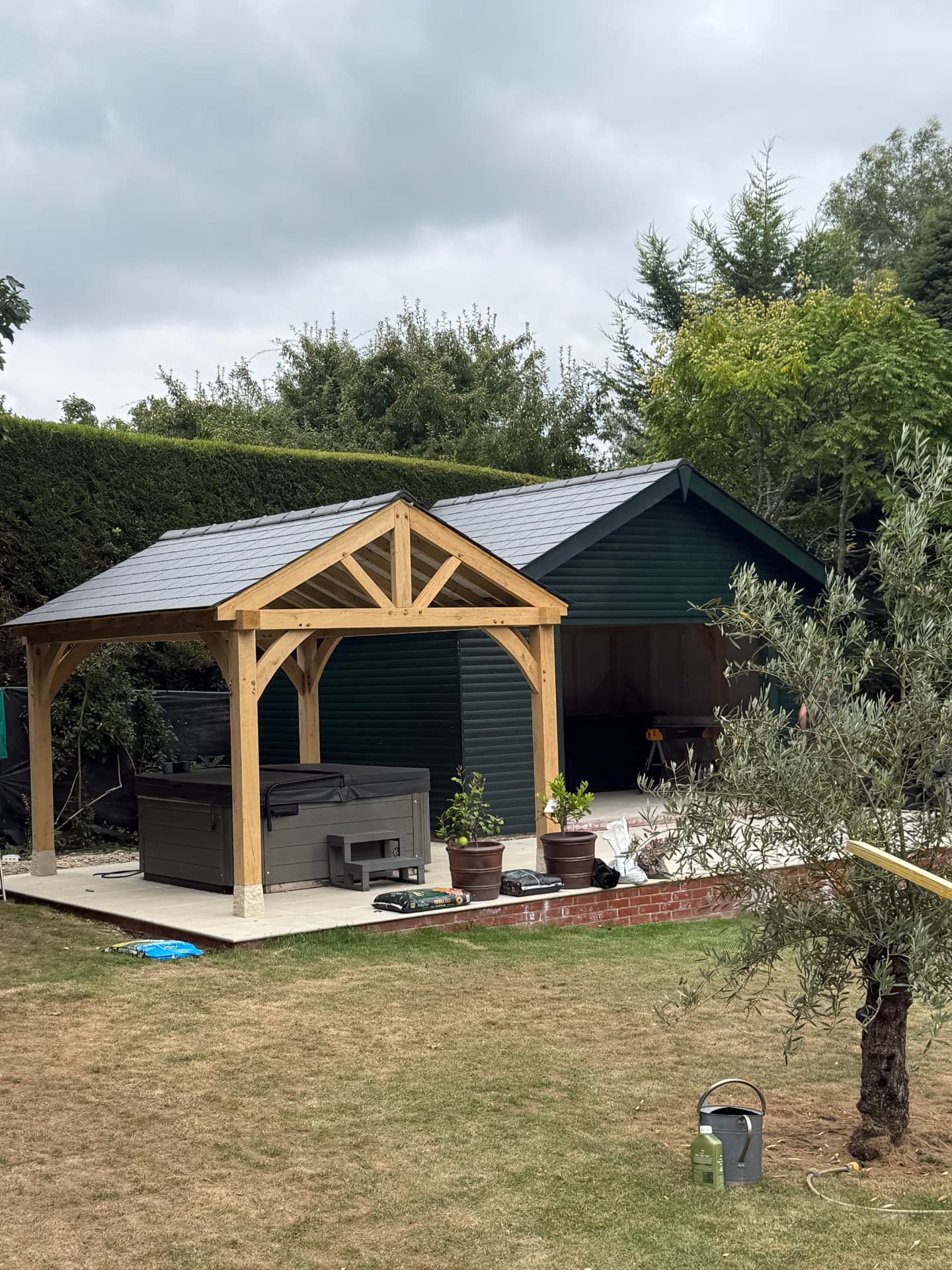 Garden building with artificial slate roofing and oak framed porch